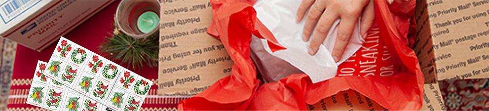 Young woman preparing holiday gifts and Priority Mail boxes to ship for December 25 delivery.